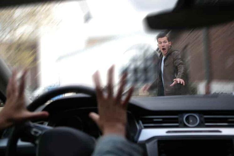 A young male pedestrian has an accident with a car