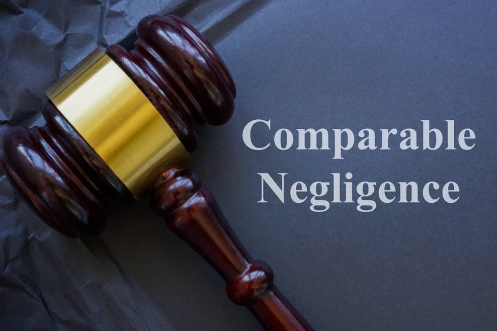Comparable negligence concept. Gavel and crumbled dark paper.