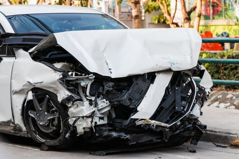 A detailed view of a car accident showcasing the extensive damage