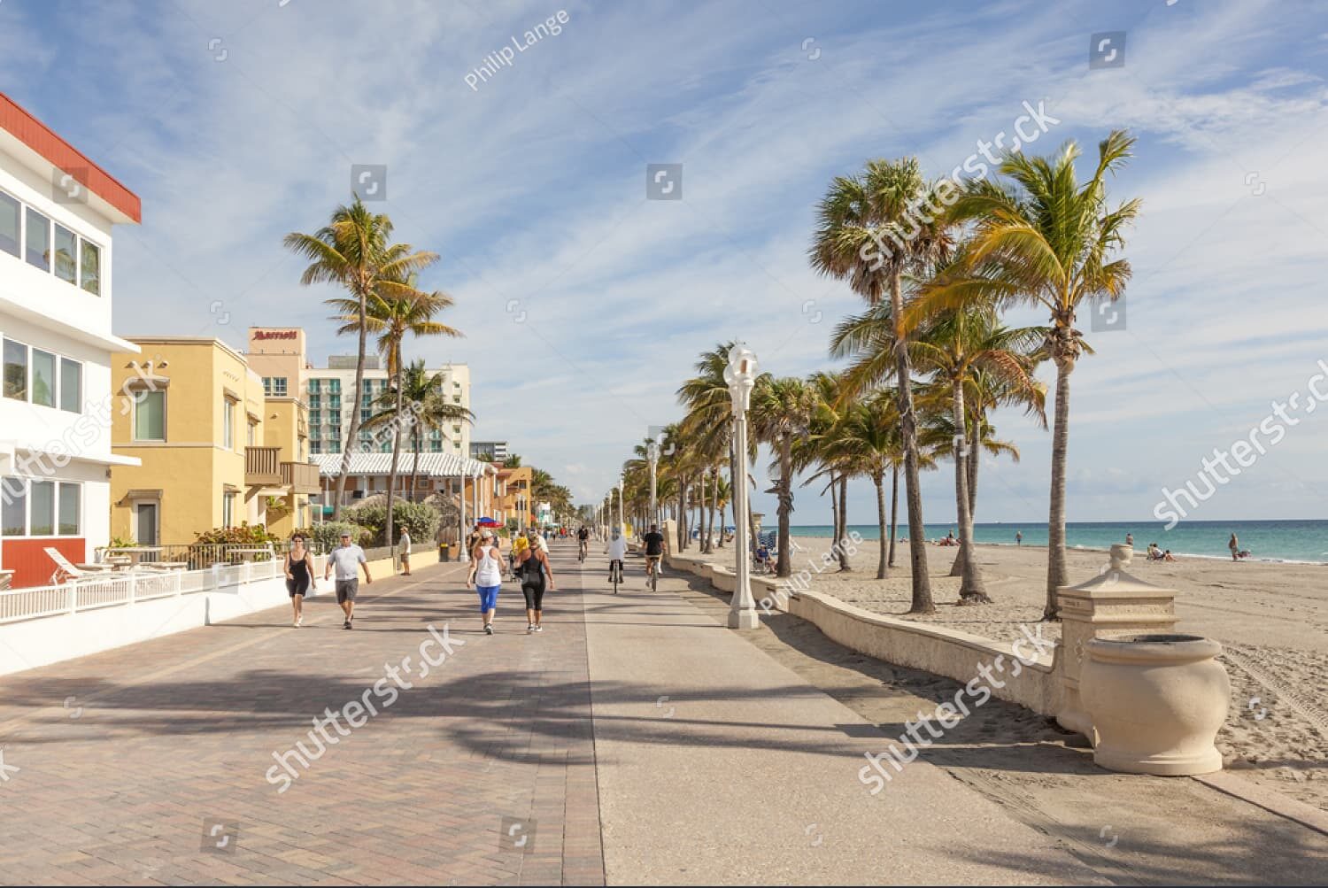 People strolling at the Hollywood Beach Broad Walk on a sunny day