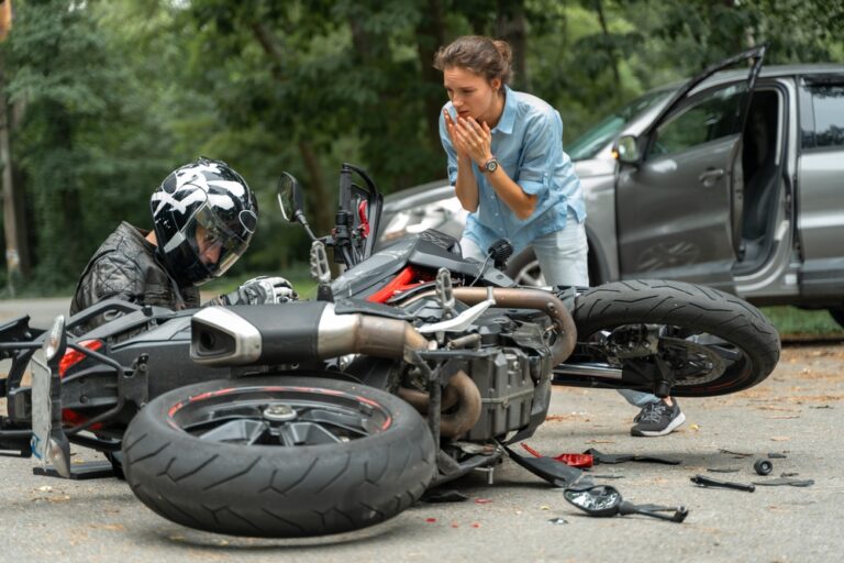 A motorcycle and a car on a road.