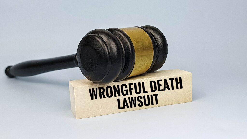 A wooden legal gavel rests on top of a small block printed with the words "Wrongful Death Lawsuit," illustrating fatal injury litigation managed by Broward County wrongful death lawyers.