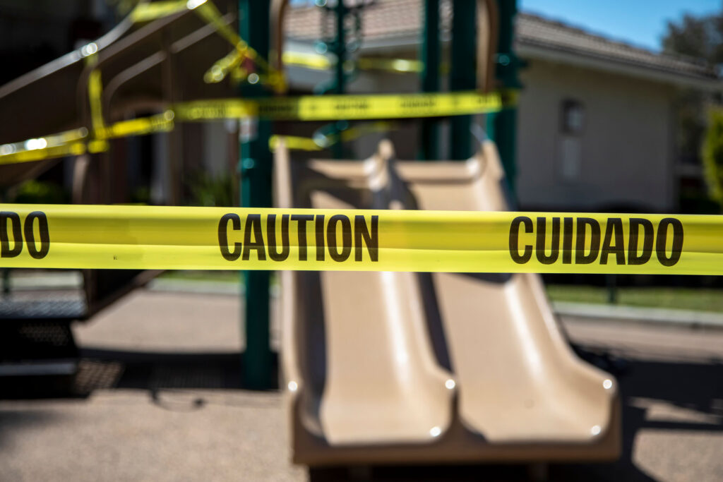 A scenic view of a brick walkway lined with palm trees and green hedges along a waterway with city high-rises, providing local context for Broward County Child Injury Lawyers.