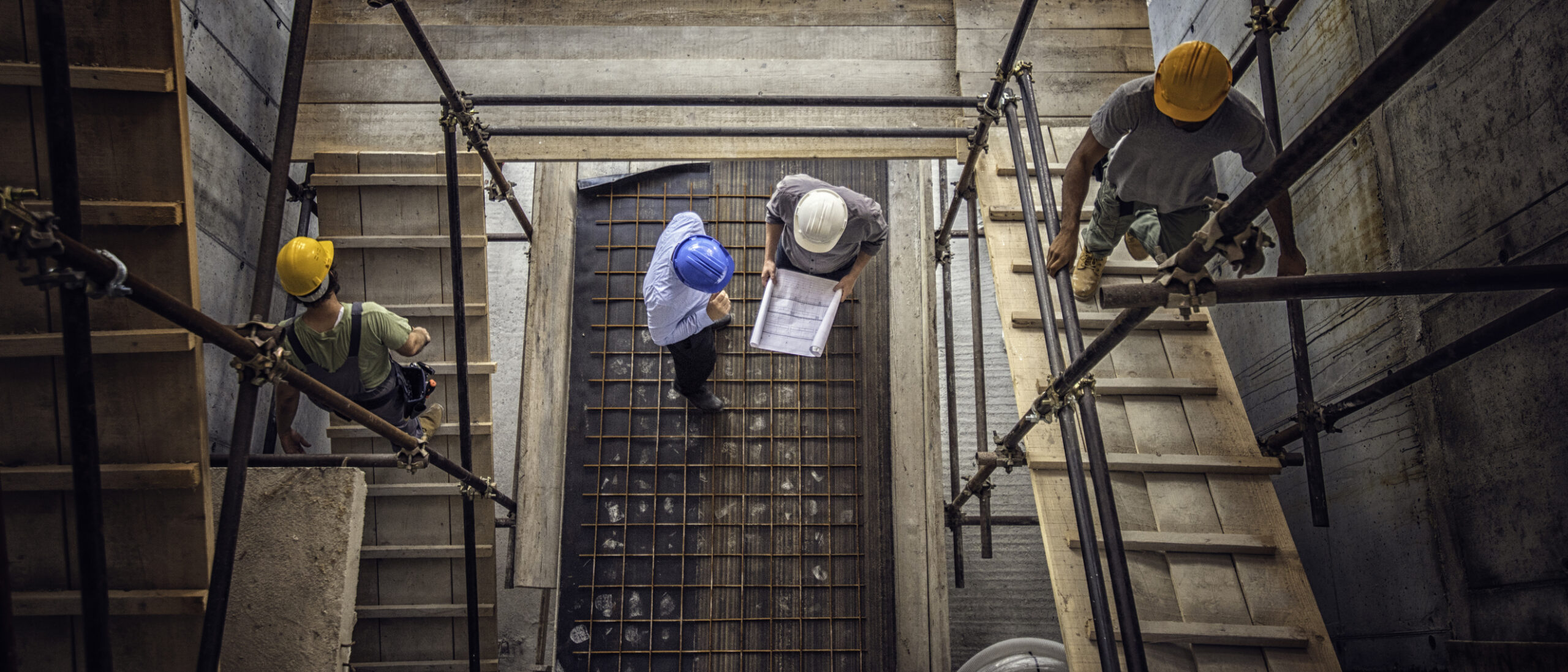 Construction workers and architects viewed from above on a work site