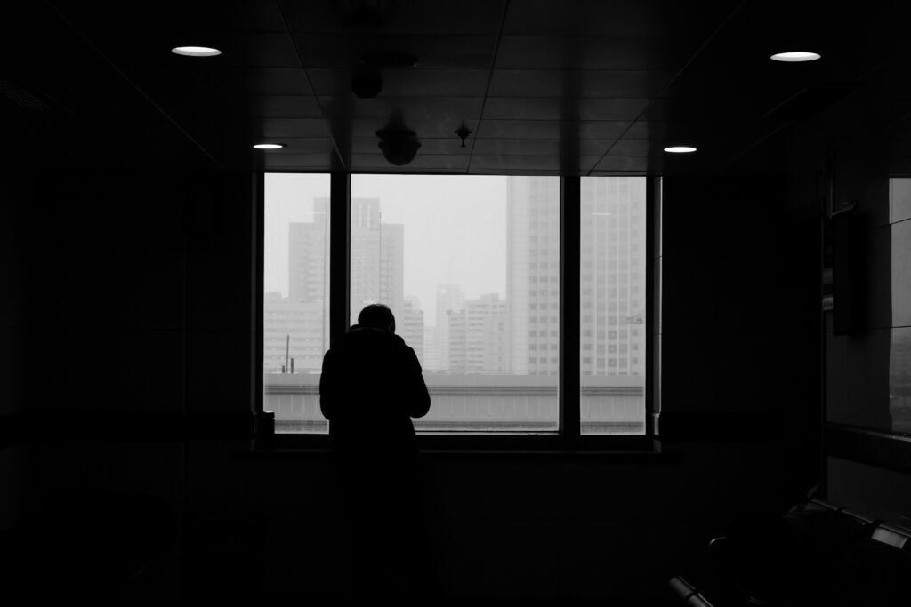 A person looking through a window.