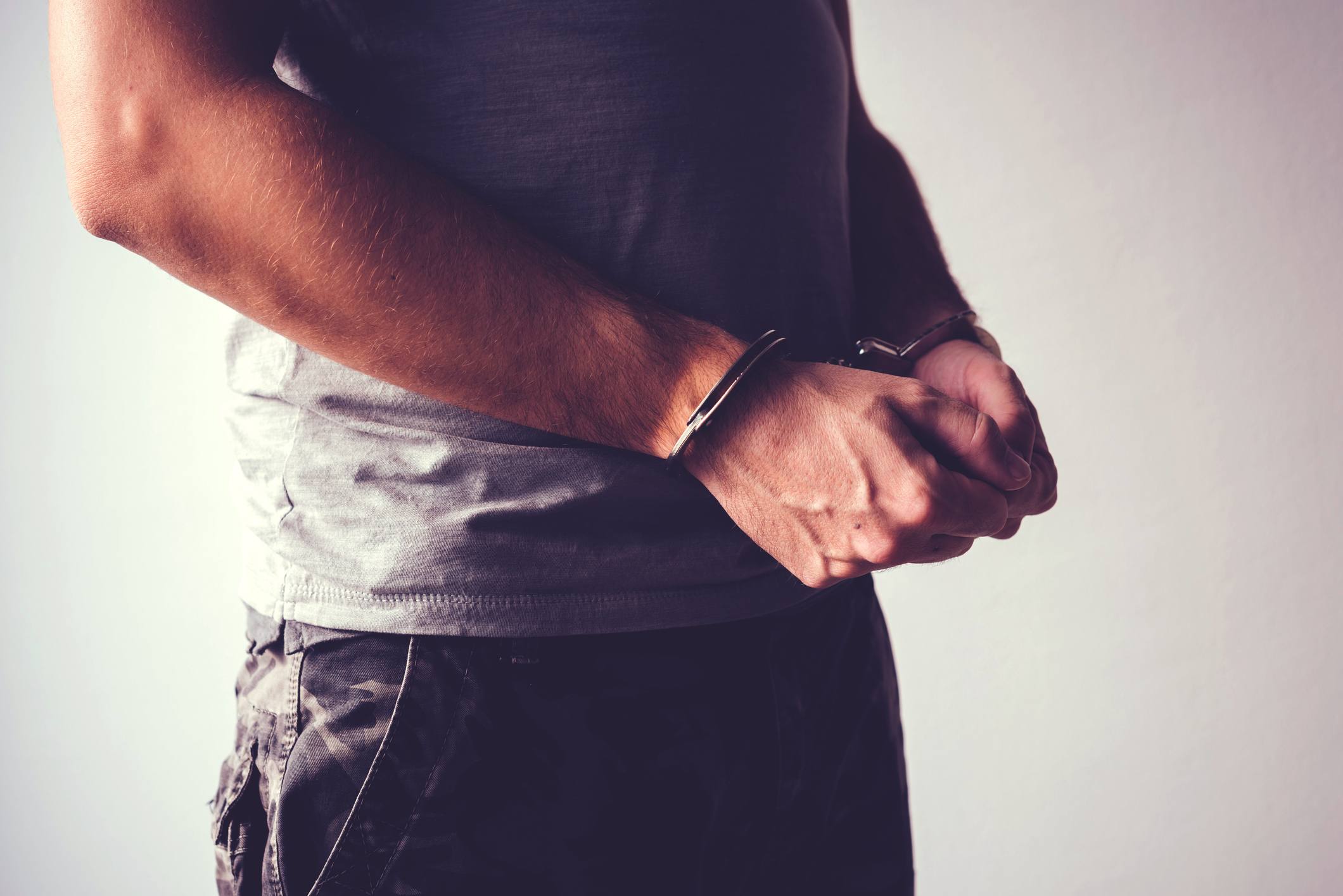 Person in handcuffs, illustrating warrant and bond defense in Pompano Beach