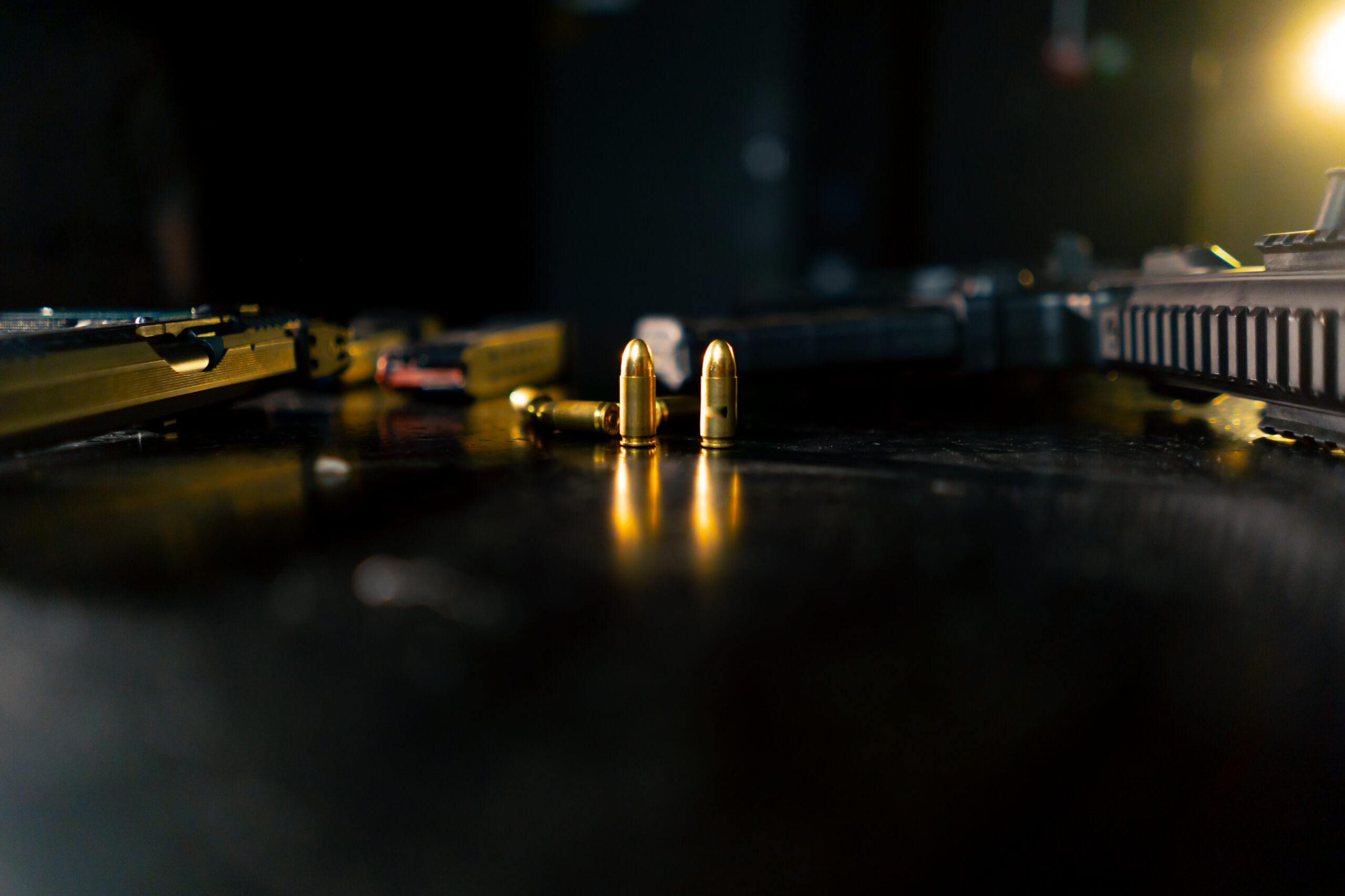 Firearms on a shooting-range table, illustrating gun possession defense in Pompano Beach