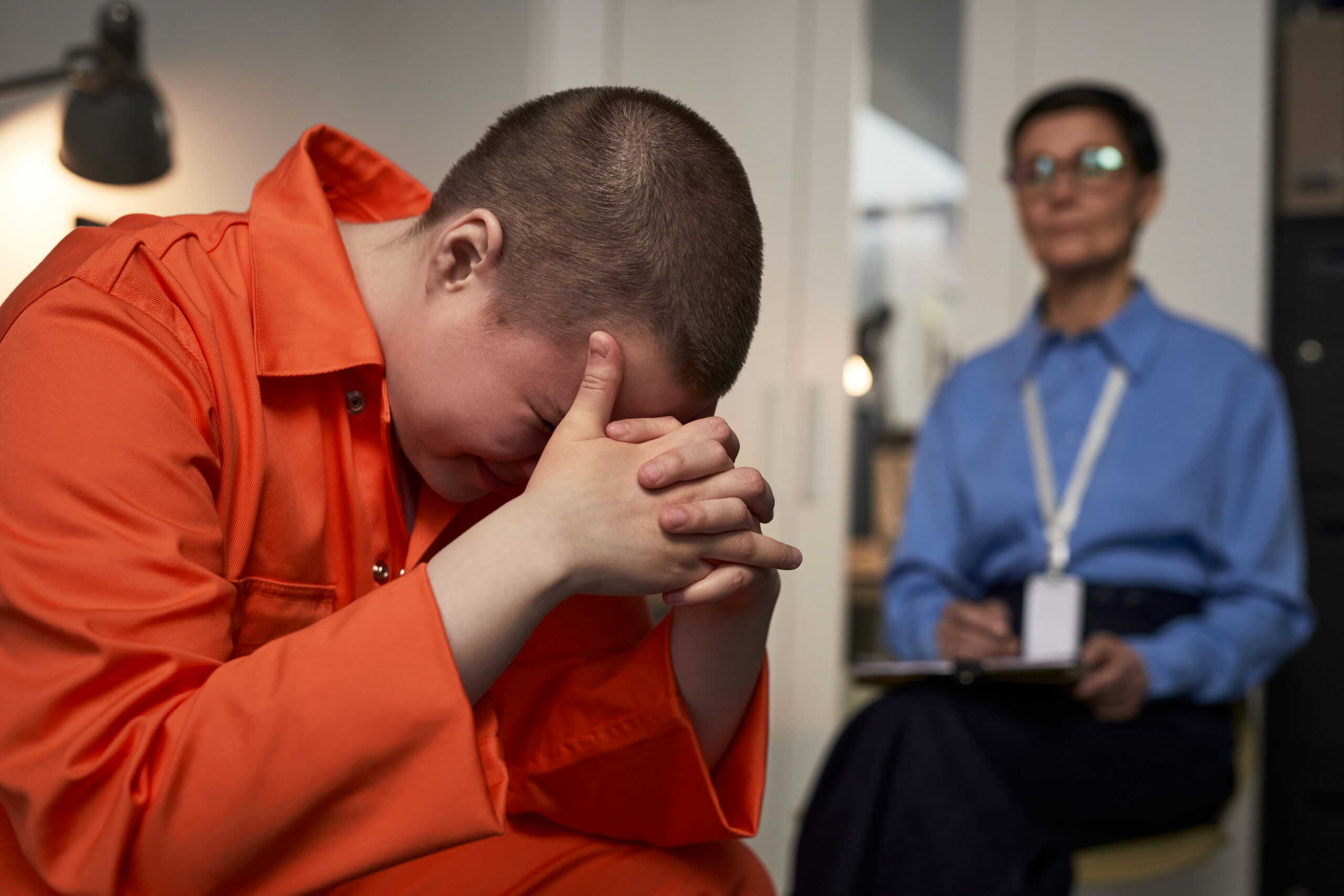 Young person with head bowed, illustrating juvenile defense concerns for Pompano Beach families